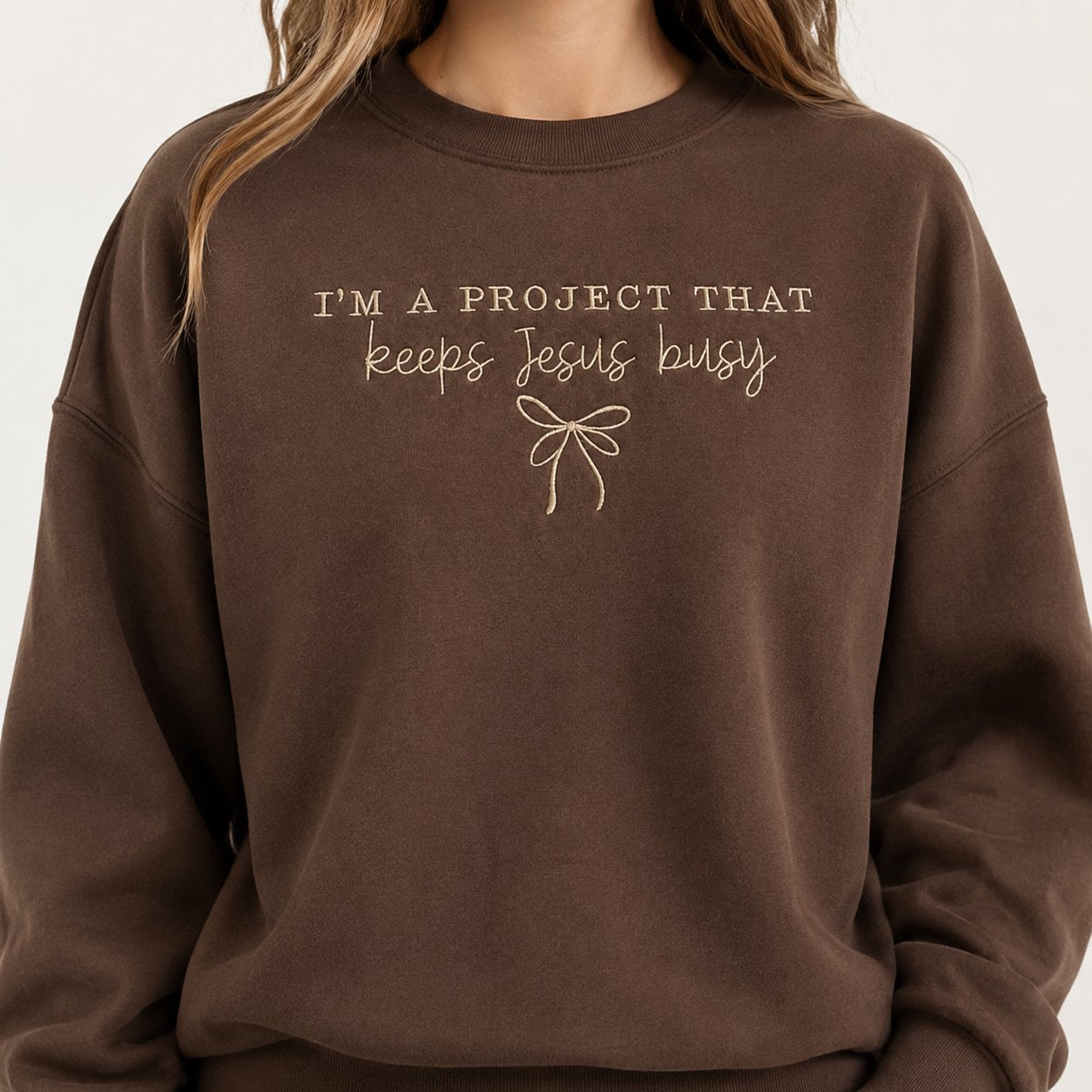 I’m a Project That Keeps Jesus Busy Embroidered Shirt, Christian Crewneck, Funny Faith Gift for Women, Coquette Bow Jesus Shirt N1EMS01
