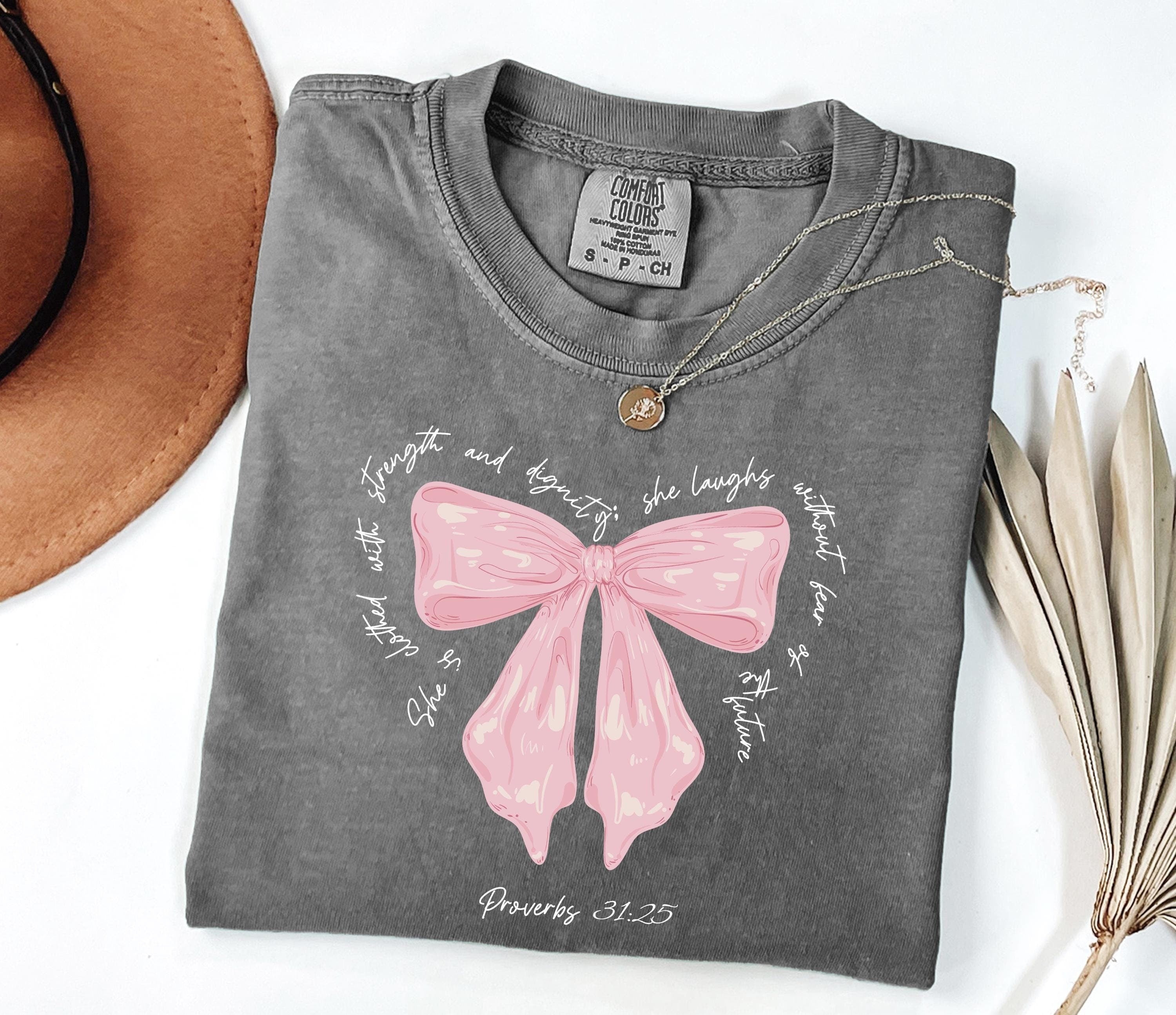 Comfort Colors® She Is Clothed With Strength Proverbs 31:25 Coquette Shirt, Bible Verse Shirt For Her, Cute Christian Gift, Mother's Day Gift, Coquette Mommy